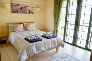a bedroom with a bed with two pillows on it at Casa Sammy in Sannat