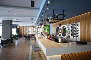 a bar in a restaurant with a bunch of wine bottles at Sea View 2-Bedroom Apartment with Water Park at Caesar Blue Resort in Boğaz