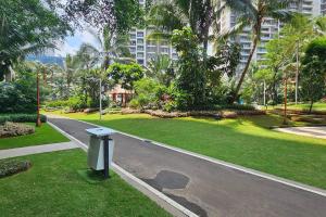 an empty street in a park with palm trees at Sky House BSD Apartemen T.Duxton in Tjilandak