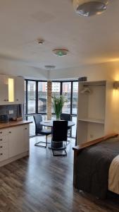 a bedroom with a bed and a kitchen with a table at 1 main street athlone in Athlone