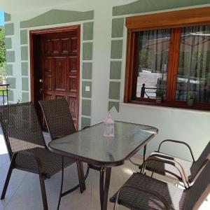 a table and chairs on a patio with a window at Tsimas House in Potamia