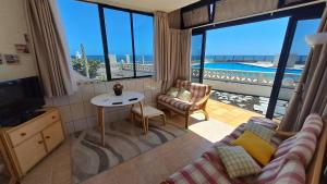a living room with a couch and a view of the ocean at VILLA SISSI Atlantic View in Costa Del Silencio