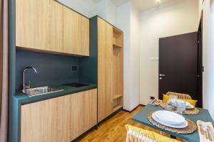 a kitchen with a table and a sink and a counter at Palazzo Quantum 1 in Milan