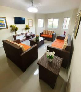 a living room with couches and tables at Jarabacoa Villa Anchorage in Jarabacoa