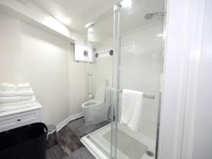 a bathroom with a glass shower and a toilet at Serene Niagara Guest House in Niagara Falls