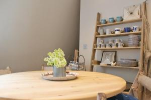 a wooden table with a vase on top of it at Elegant Georgian Maisonette - Central Bath in Bath +36 photos