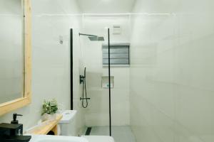 a bathroom with a shower and a toilet at Kashco Apartments Wuse 2 Abuja in Abuja