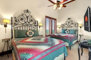 a bedroom with two beds and a ceiling fan at Arc de Texas -Joan of Arc Suite in Johnson City