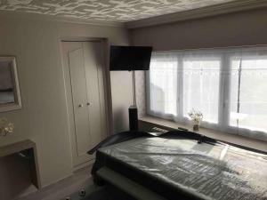 a bedroom with a bed and a window at MAISON AVEC JACUZZI PRIVATIF in Saint-Aubert