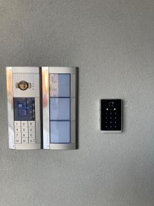 a remote control hanging on a wall at Itinera Home Residence in Montalto Uffugo