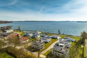 an aerial view of a town by the water at Hangar 19 Luxusbungalow am See H8 in Schwerin