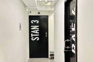 a black door with a sign on it in a hallway at Rucksack Inn Temple Street in Singapore