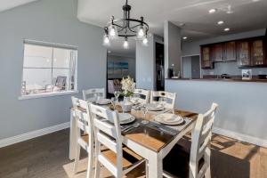 a dining room and kitchen with a table and chairs at Encantamar Escape in Dana Point