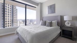 a bedroom with a large bed with a large window at Landing at The 600 - 2 Bedrooms in Fountain Heights in Birmingham