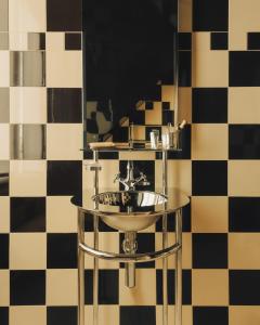 a bathroom with a sink in front of a mirror at Hôtel Château d'Eau in Paris