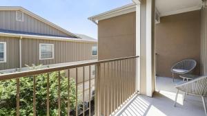 a balcony of a house with a chair and a table at Landing at Mission Hill - 1 Bedroom in New Braunfels in New Braunfels