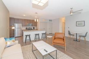 a living room with a couch and a kitchen at Landing at San Marco Promenade - 1 Bedroom in San Marco in Jacksonville