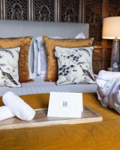 a room with a bed with pillows on a table at Domaine du Chesney in Pressagny l'Orgueilleux