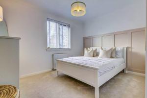 a white bedroom with a large white bed with white pillows at Shawfarm - Open Championship 24 in Monkton