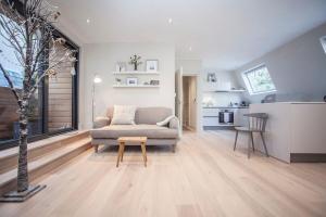 a living room with a couch and a table at Stylish Wood Street Apartment in Bath