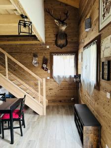 a log cabin with a bunk bed and a table and chairs at La Tanière in Samoëns +1 photo