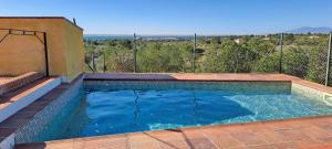 a swimming pool with blue water on a patio at Casa Mola in Perelló