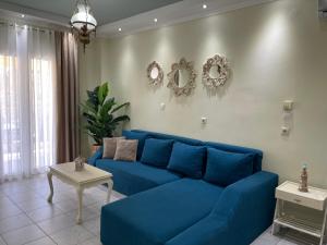 a blue couch in a living room with a table at Olivia - Christine's House in Afitos