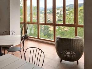 a room with a table and chairs and a large window at 6 bedrooms house with furnished garden and wifi at Otanes 4 km away from the beach in Otañes