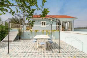 a table and chairs on a patio with a house at Host Wise - Spacious Comfortable House Pool in Amarante