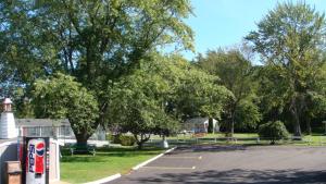 a parking lot with trees and a pepsi machine at Beachway Motel in Salisbury