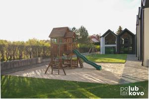 a playground with a slide and a swing at POLUBKOVO domki wypoczynkowe sauna balia basen jezioro in Lubkowo