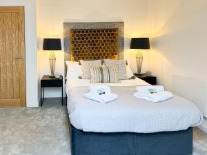 ein Schlafzimmer mit einem großen Bett mit Handtüchern darauf in der Unterkunft Free Parking - Central - Penthouse in York