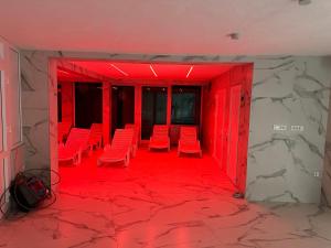 a room with red chairs and a red floor at Villa Sarajevo in Vareš