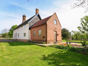 an old brick house with a grass yard at Brook Farm in Harleston