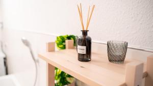 a bottle on a table with a glass on it at Altstadt I Glasfaser I Business I free parking in Quedlinburg +16 photos