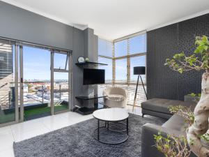a living room with a couch and a table at Upper East Side 407 in Cape Town