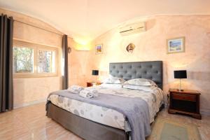 a bedroom with a large bed and a window at Casa Matteu in Figari