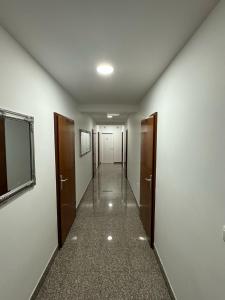 an empty hallway with two doors and a hallwayngth at VILLA ŠIMOVIĆ APARTMENTS in Baška Voda