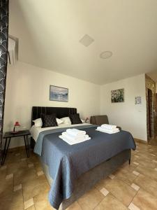 a bedroom with a bed with two towels on it at VILLA ŠIMOVIĆ APARTMENTS in Baška Voda