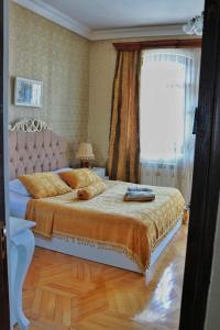 a bedroom with a bed and a window at Luxor Gardens in Batumi