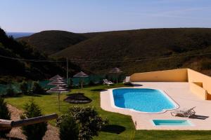 a swimming pool in the middle of a yard at Falésias da Arrifana in Praia da Arrifana