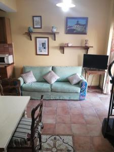 a living room with a green couch and a table at La Casa nella Pineta in Fiuggi +23 photos