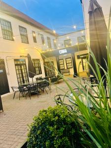 a courtyard with tables and chairs in a building at Lion Hotel in Worksop