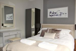 a bedroom with a white bed and a mirror at ※ Lovely Central Bath House- with Parking ※ in Bath