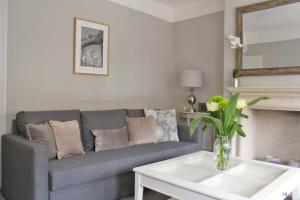 a living room with a couch and a table at ※ Lovely Central Bath House- with Parking ※ in Bath