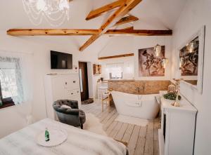 a bathroom with a bath tub and a sink at Dom dla dwojga w Starym Młynie w Brzeźnicy in Brzeźnica