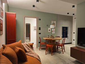 a living room with a couch and a table at Bolghera House in Trento