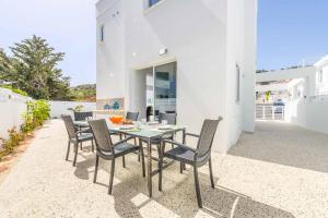 a table and chairs on the patio of a house at Green Bay Villa 14 in Protaras