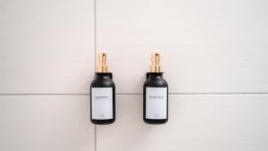 two black bottles sitting on a white tiled floor at Altstadt I Glasfaser I Business I free parking in Quedlinburg