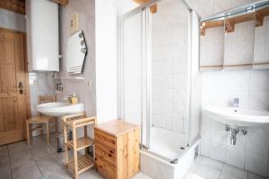 a bathroom with two sinks and a shower at Appartements Zettler in Donnersbachwald